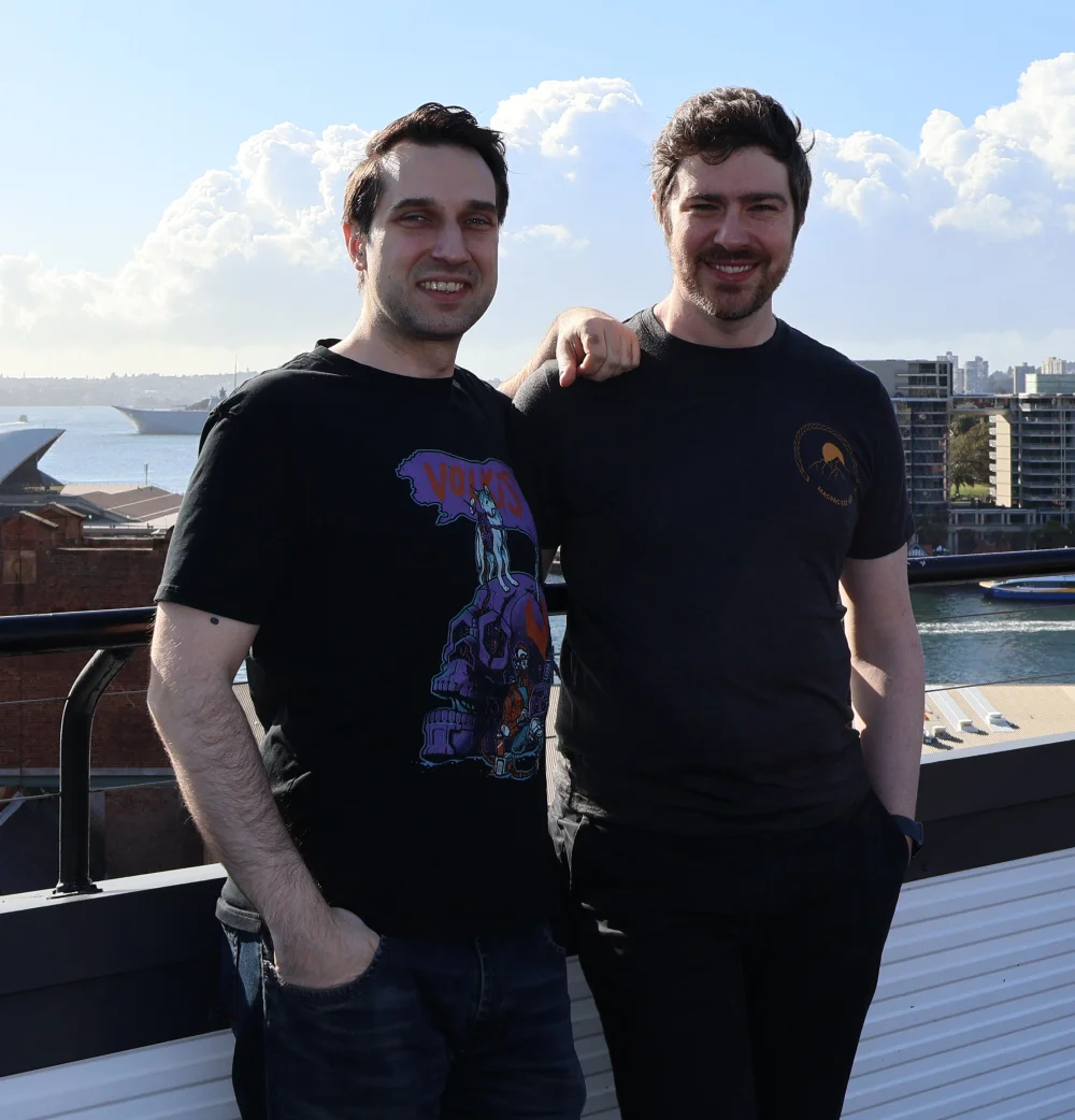 Matt and Alexei standing on a rooftop overlooking Sydney Harbour